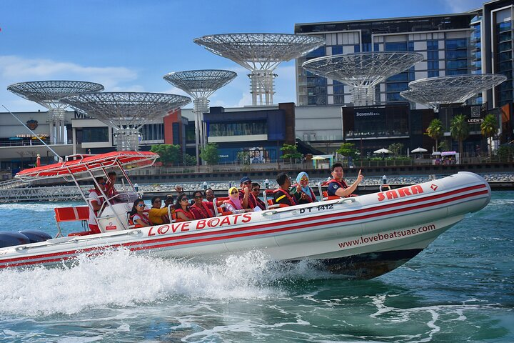 Experience the stunning Dubai skyline from a speedboat enjoying refreshing ocean breezes and spectacular views of iconic landmarks while sharing laughter and excitement with friends and family.